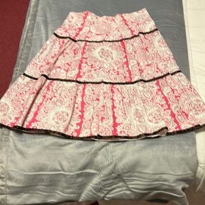 Pink Stripe brand pink paisley/floral skirt with brown ribbon trim.
